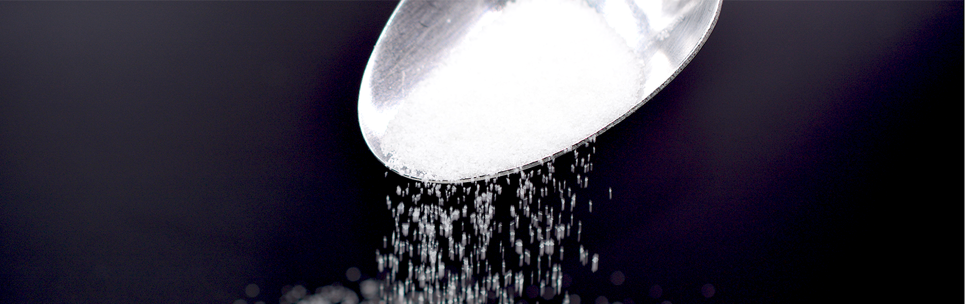 Superabsorbent polymer products being poured from a spoon